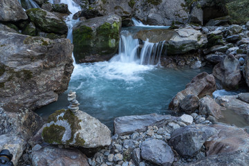 Fototapeta na wymiar Mountain river and stones landscape natural environment. Hiking in the alps. Grawa Waterfall in Stubai Valley, Tyrol, Austria