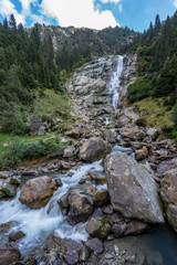 Mountain river and trees landscape natural environment. Hiking in the alps. Grawa Waterfall in Stubai Valley, Tyrol, Austria