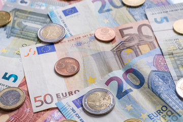 Euro bank notes and coins close up as background
