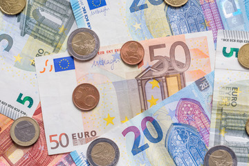 Euro bank notes and coins close up as background