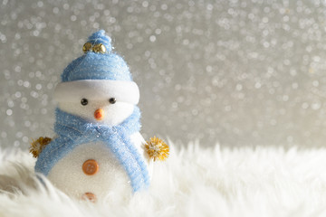 Happy snowman standing in winter christmas snow background. Merry christmas and happy new year greeting card with copy-space. Christmas celebration holiday background.