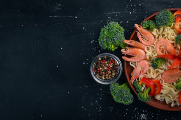 Asian food with seafood and vegetables. Shrimp, broccoli, paprika, spices. Top view. Free space for text.
