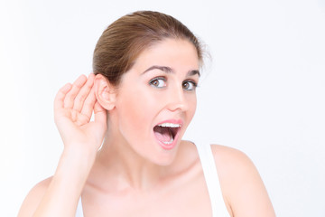 Girl listening with her hand on an ear