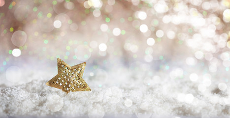 Golden star on Christmas snowy bokeh background