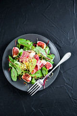 Salad with figs prosciutto and grated cheese