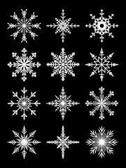 Fototapeta na wymiar Patterned white snowflakes on a black background