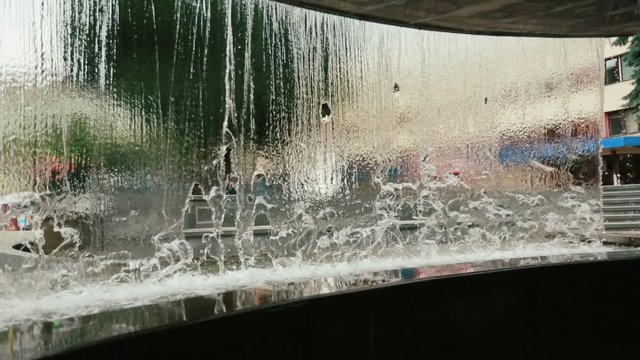 Look from the inside at water falling from the fountain