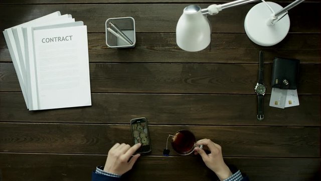 A man uses his phone.