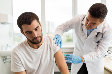 patient and doctor with syringe doing injection