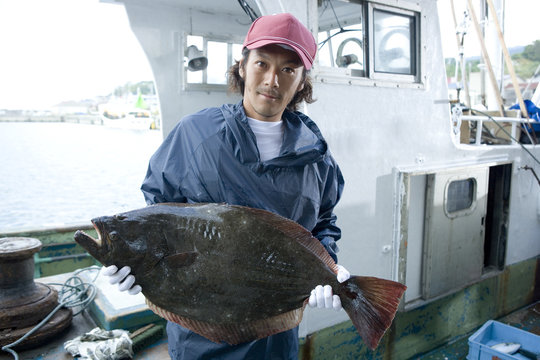 Portrait of fisherman holding fish