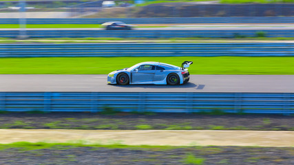 Motion Blur race car racing on speed track, Super car race on the international race track crossing...