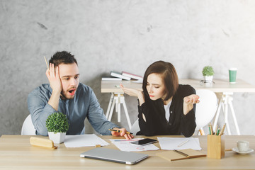 European businessman and woman doing paperwork