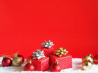Gift box with Christmas ball decoration on red background,Christmas background concept.