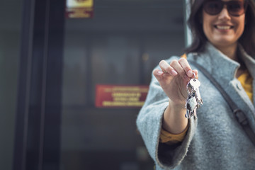 Woman holding keys of her new home.