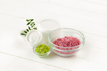 Spa concept with salt, mint, lotion, towel on white background