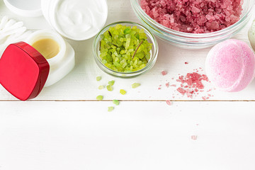 Spa concept with salt, mint, lotion, towel on white background