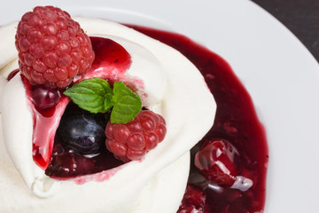 homemade pavlova meringue cake with raspberries and blueberries