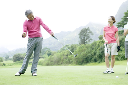 Senior man playing golf at a golf course