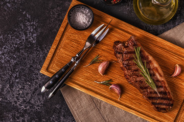 Beef steak on a dark background.