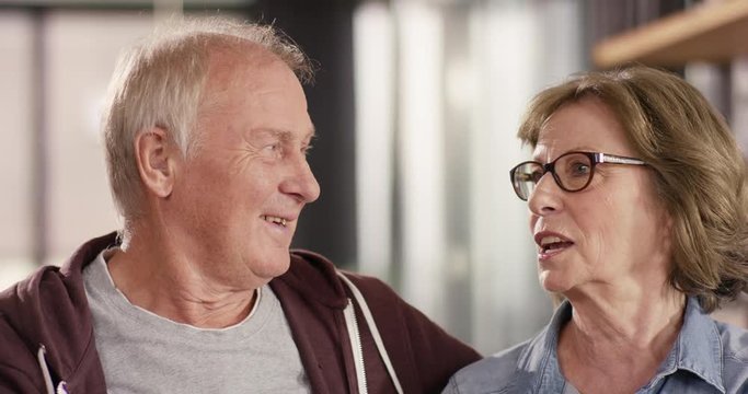 Portrait of attractive Senior Couple talking at home