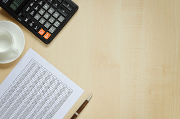 Obraz premium Calculator, document, cup for coffee and a pen