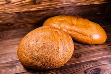 Different loafs of bread on wooden table