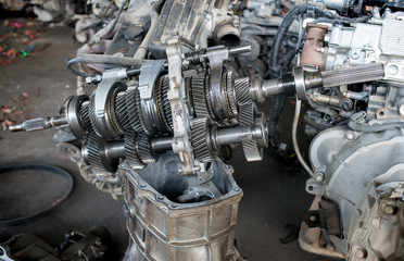 Fototapeta premium Used and old car engine gear in the recycle garage for sale.