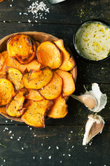 Sweet fried potatoes with spices, salt and sauce