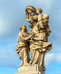 Fototapeta na wymiar Prague, Czech Republic - October 12, 2017: The statue of Saint Anne installed on the north side of the Charles Bridge in Prague, Czech Republic
