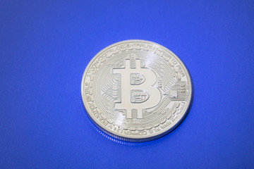 Golden Bitcoins digital virtual money on a blue background.