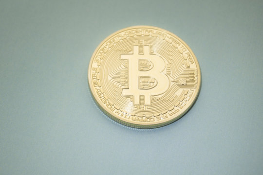 Golden Bitcoins digital virtual money on a black gray background.