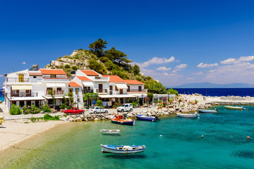 Fototapeta na wymiar The picturesque village of Kokkari with traditional houses and fishing boats. Kokkari village is a popular tourist place on the island of Samos.