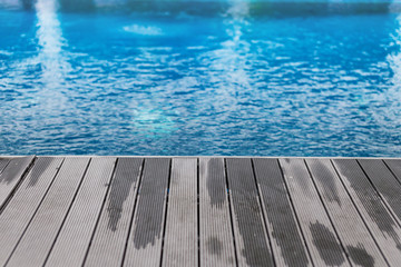 wooden deck with swimming pool side