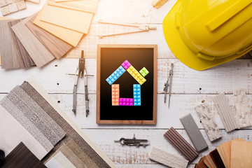 house design concept with material sample house model tool light bulb on wooden background with free copyspace for your ideas text