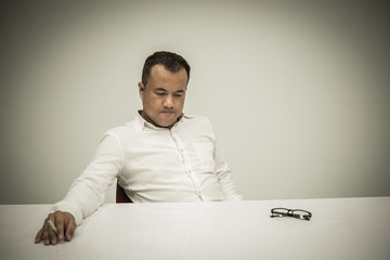 Businessman stress from hard with ciggarette in hand on white background