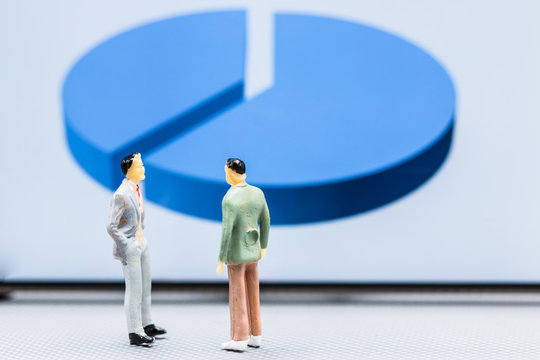 Miniature People : Small Figures Businessmen Stand With Graph Market Share Display With Copy Space And Using As Background Finance Business Team Competition Concept, Business Plan Concept.