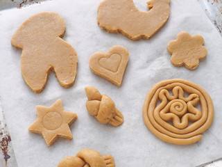 Cooking process. Preparing Christmas treat. Figured cookies ready for baking. 