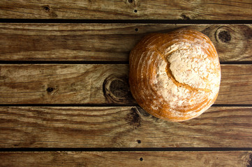 Traditional bread on wooden table view from above