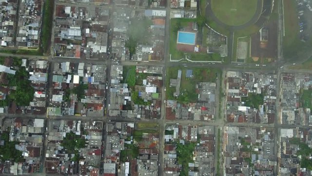 Aerial shot over town and futbol/soccer stadium in Colombia
