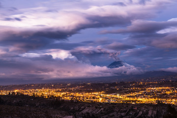 Clouds and ash of the Cotopaxi volcano is dramatically mixed at dusk