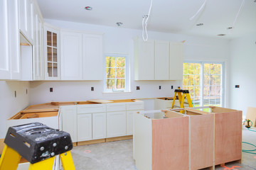 Custom kitchen cabinets in various stages of installation base for island in center