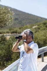 Man watching with binoculars