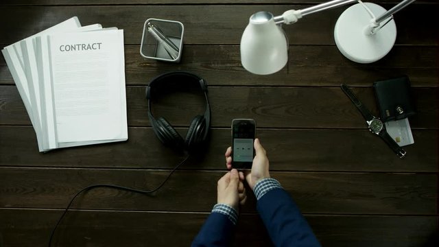 A man starts listening to music on headphones.