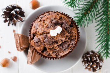 Fototapeta na wymiar Christmas chocolate muffin on white wooden table.
