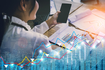 asian business girl working with smartphone and paper graph business finance document