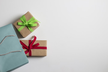 Shopping bag and gifts boxs with a bows on a withe background