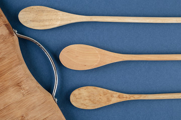 kitchen cutting board and a wooden spoon on a blue