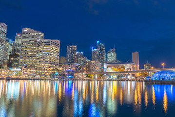 Fototapeta na wymiar SYDNEY - OCTOBER 2015: Night view of Darling Harbour skyline. Sydney attracts 15 million people annually