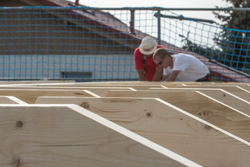 Roofers make the roof of a house in traditional construction