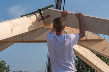 Roofers make the roof of a house in traditional construction